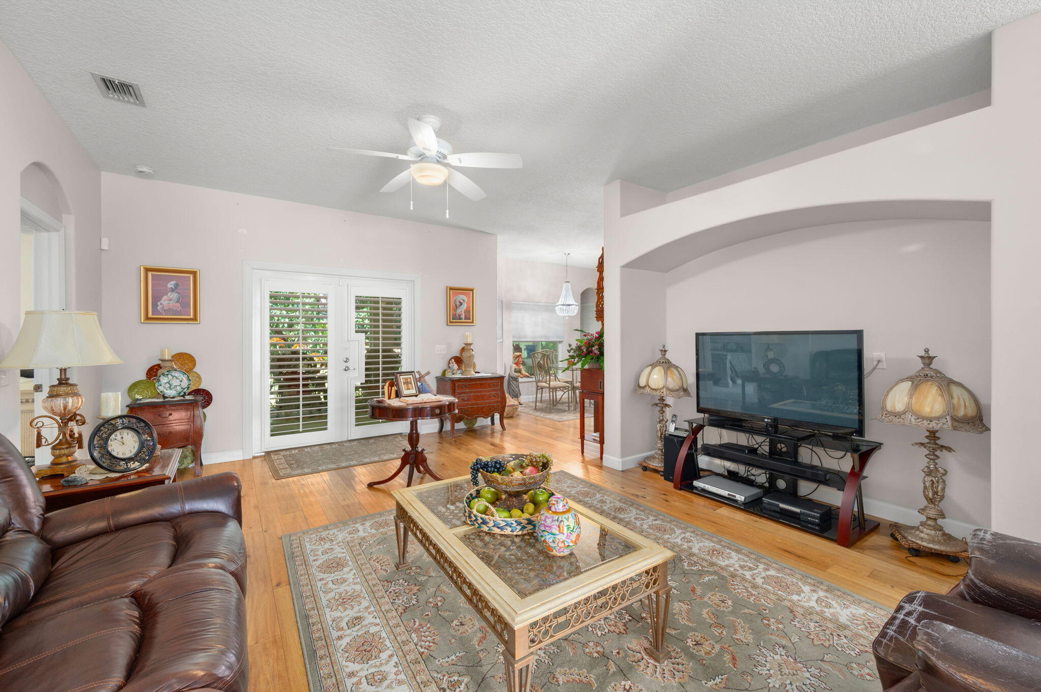 1545 Southwest Mockingbird Circle Port St. Lucie, FL 34986 - Photo 8 of 24 a living room with furniture and a flat screen tv