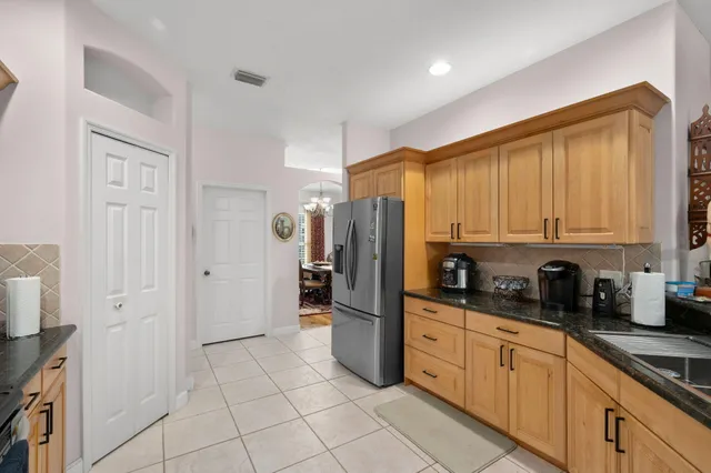 a kitchen with stainless steel appliances a refrigerator sink and cabinets