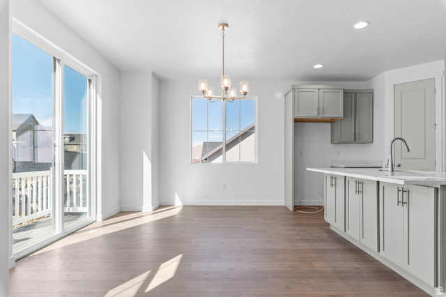 1024 South Tanner Road Santaquin, UT 84655 - Photo 11 of 20 Unfurnished dining area featuring a chandelier and dark wood-type flooring