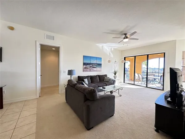 a dining room with wooden floor and a chandelier