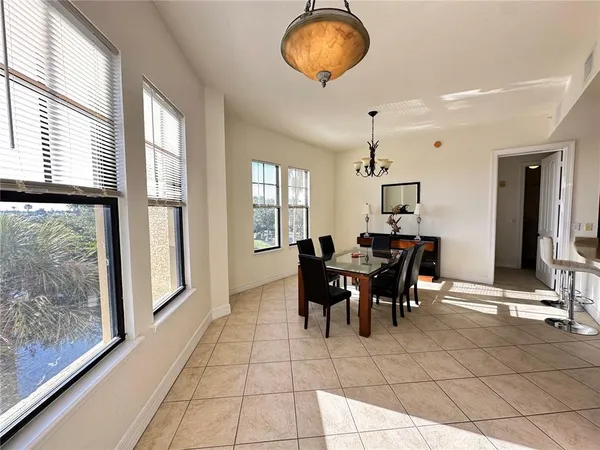 a bathroom with a granite countertop sink a toilet a mirror and bathtub