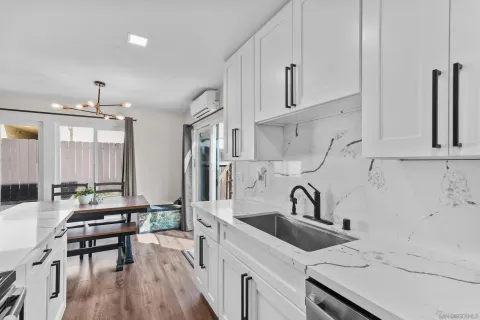 a kitchen with a sink cabinets and wooden floor