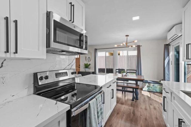 a kitchen with stainless steel appliances a stove microwave and cabinets