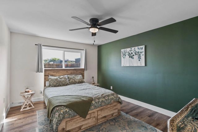 a bedroom with a bed and a window