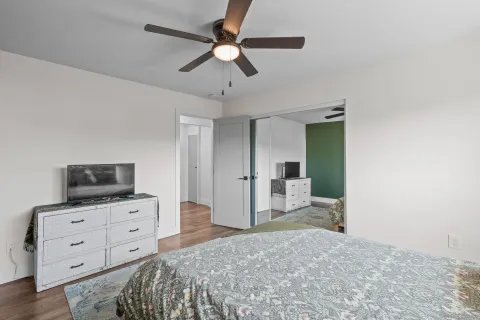 a bedroom with a bed and a flat screen tv