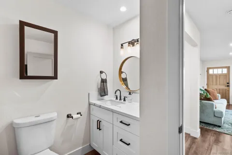 a bathroom with a toilet sink and mirror