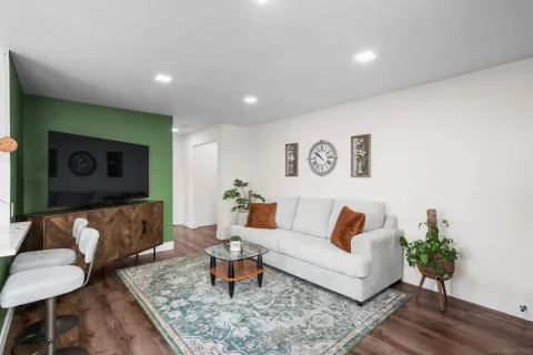 a living room with furniture and wooden floor