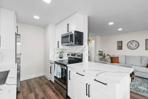a kitchen with stainless steel appliances granite countertop a stove and a sink