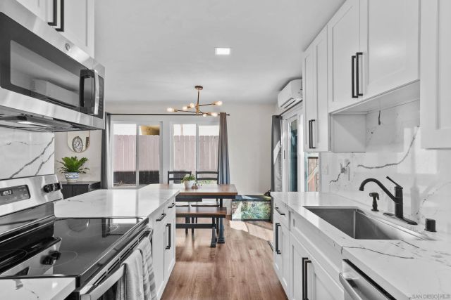 a kitchen with counter top space a sink appliances and cabinets