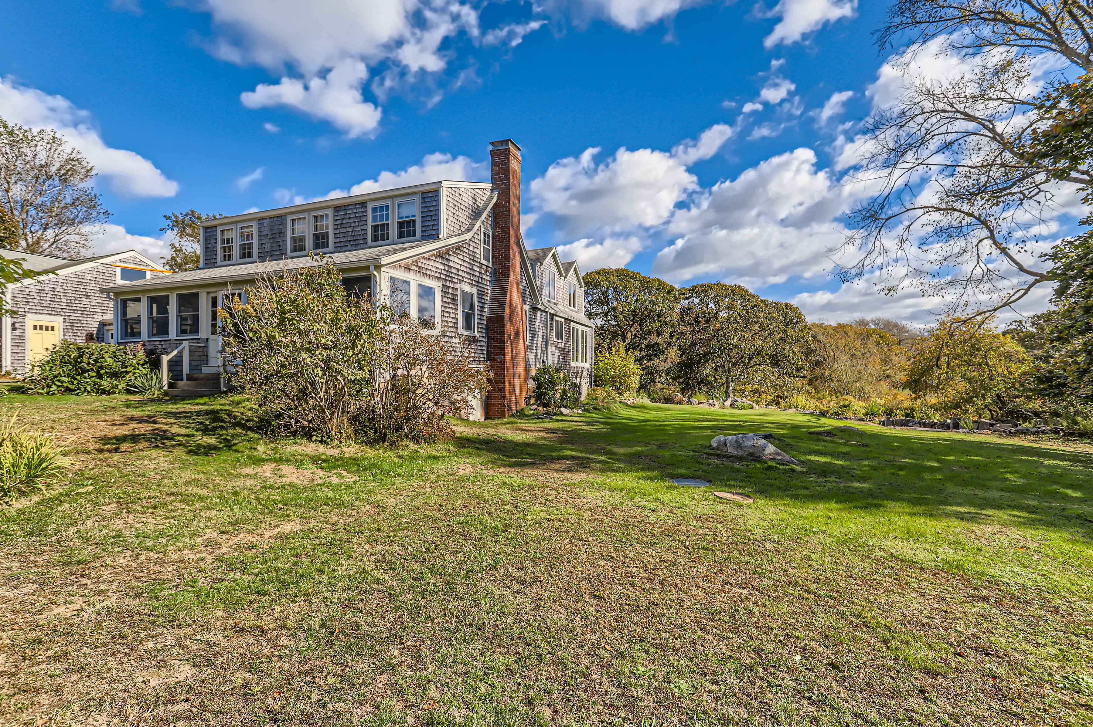 76 State Road Chilmark, MA 02535 - Photo 15 of 79 a front view of a house with a yard