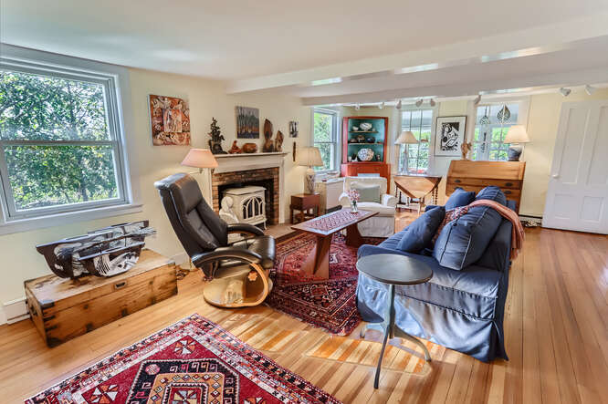 76 State Road Chilmark, MA 02535 - Photo 29 of 79 a view of a livingroom with furniture a fireplace and wooden floor