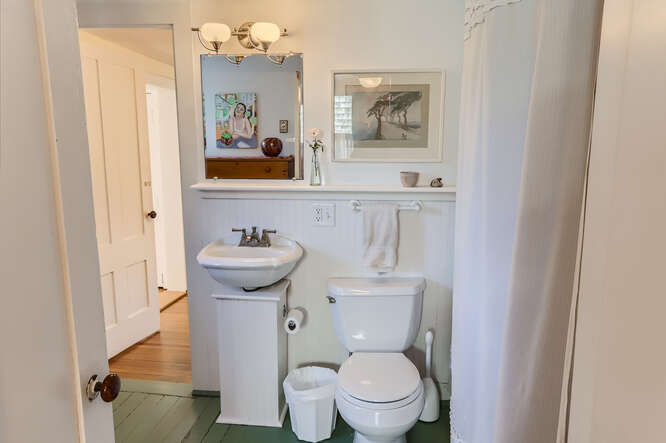 76 State Road Chilmark, MA 02535 - Photo 35 of 79 a bathroom with a toilet sink and mirror