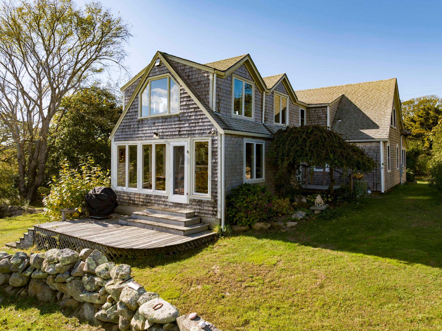 76 State Road Chilmark, MA 02535 - Photo 9 of 79 a front view of a house with swimming pool and porch