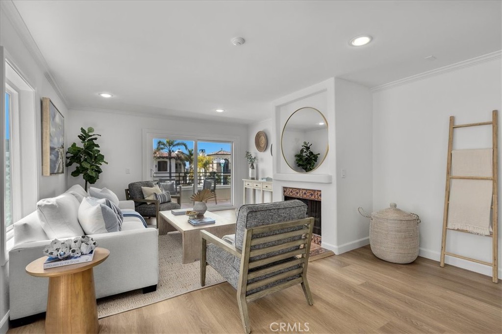 700 Esplanade, Unit 5 Redondo Beach, CA 90277 - Photo 1 of 1 a living room with furniture a mirror and a fireplace