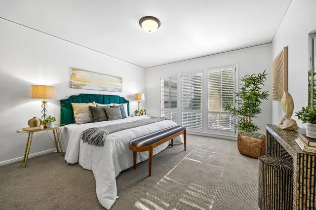 a bedroom with furniture and a potted plant