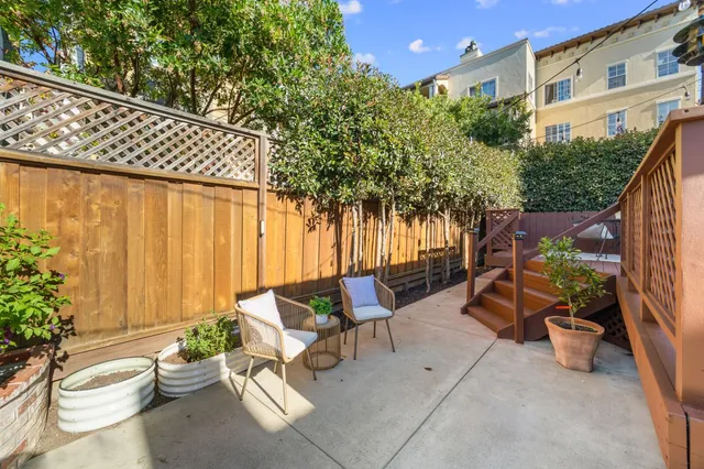a view of a patio with couches and potted plants