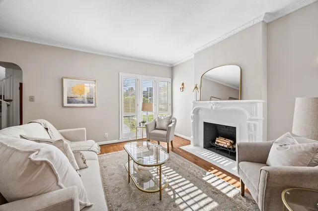 a living room with furniture a rug and a fireplace
