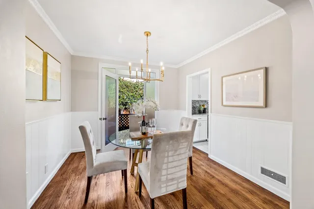 a view of a dining room with furniture window and wooden floor