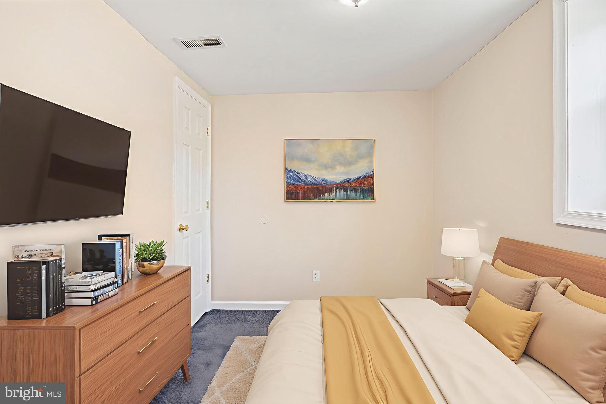 2114 Oakland Road Baltimore, MD 21220 - Photo 12 of 21 a bedroom with a bed and a flat screen tv