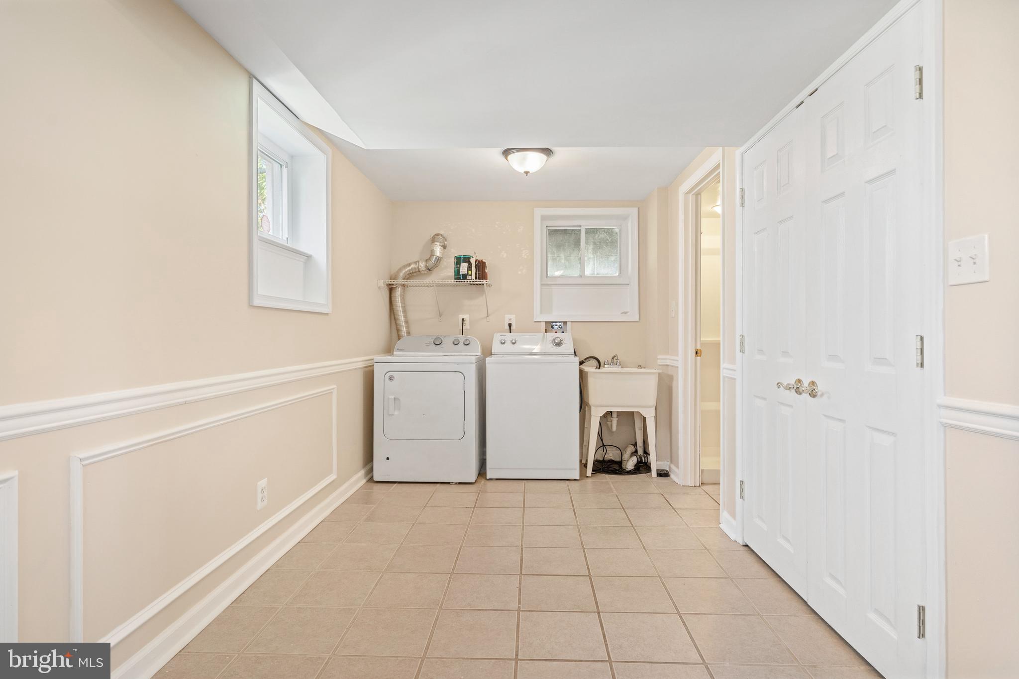 2114 Oakland Road Baltimore, MD 21220 - Photo 13 of 21 a view of a storage & utility room with closet dryer and washer