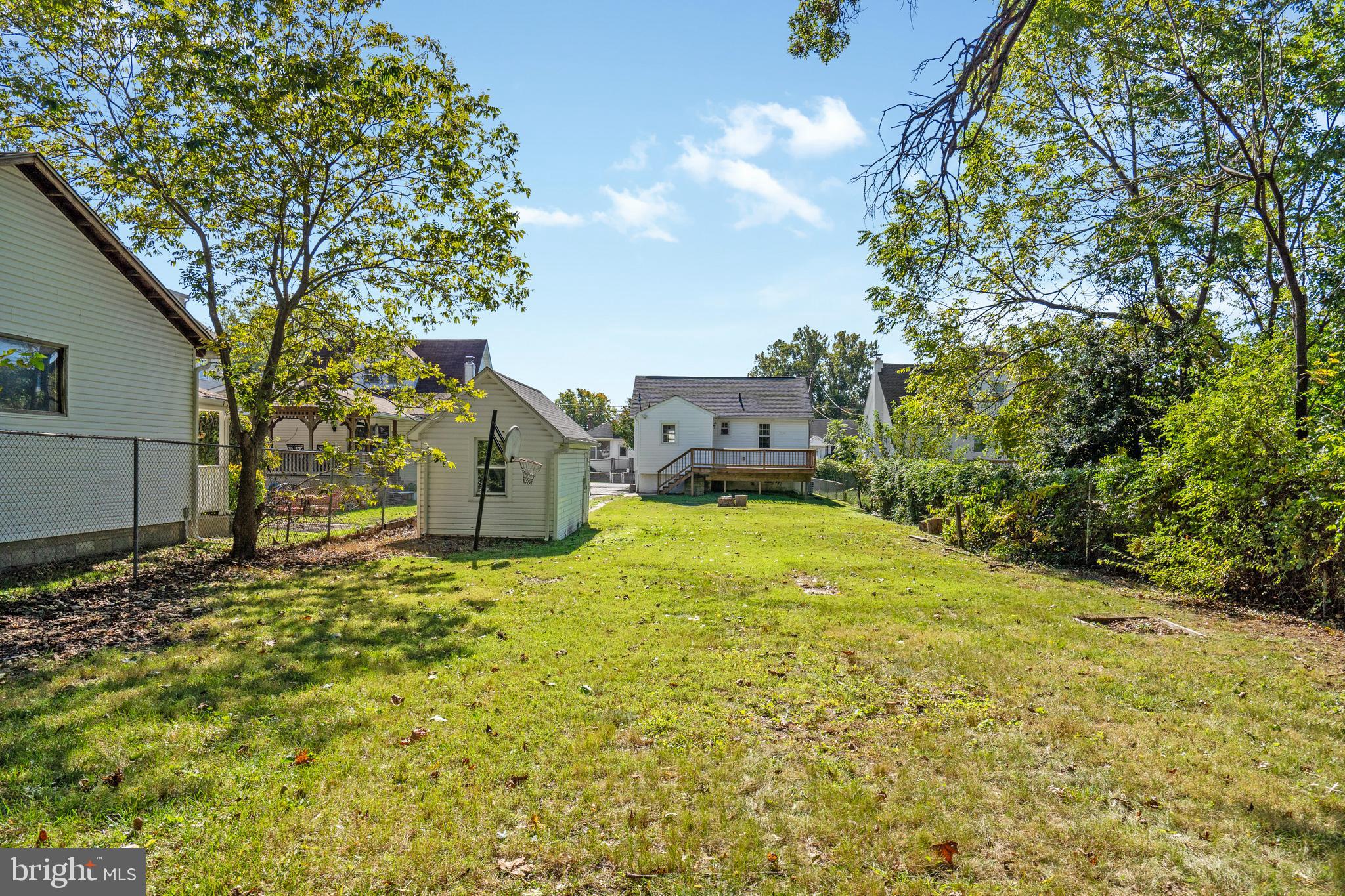 2114 Oakland Road Baltimore, MD 21220 - Photo 21 of 21 a yellow house with trees in front of it