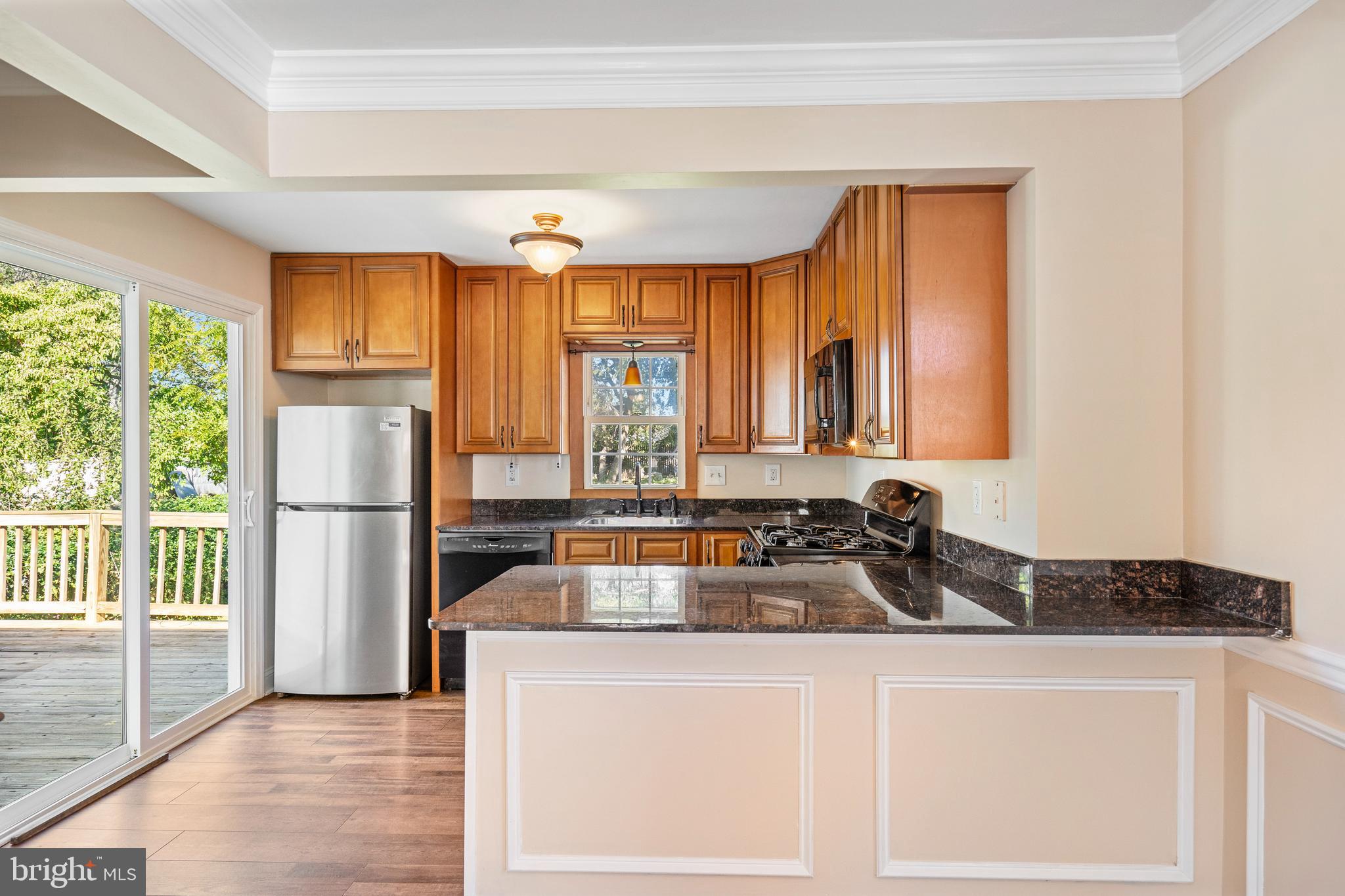 2114 Oakland Road Baltimore, MD 21220 - Photo 5 of 21 a kitchen with a sink a refrigerator and large window