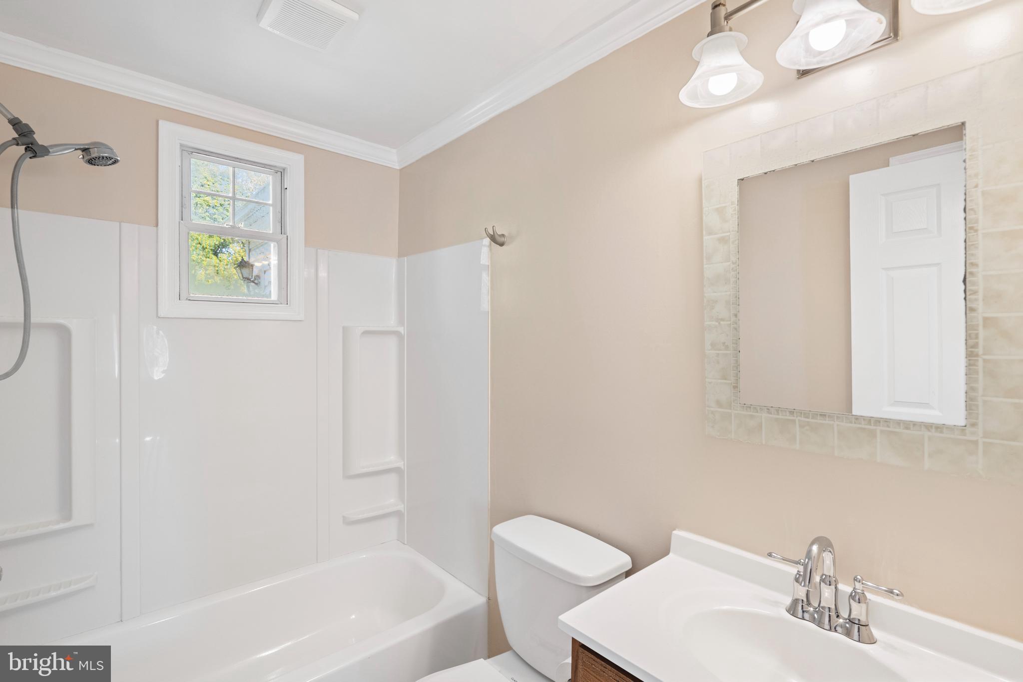 2114 Oakland Road Baltimore, MD 21220 - Photo 10 of 21 a bathroom with a sink a toilet and shower