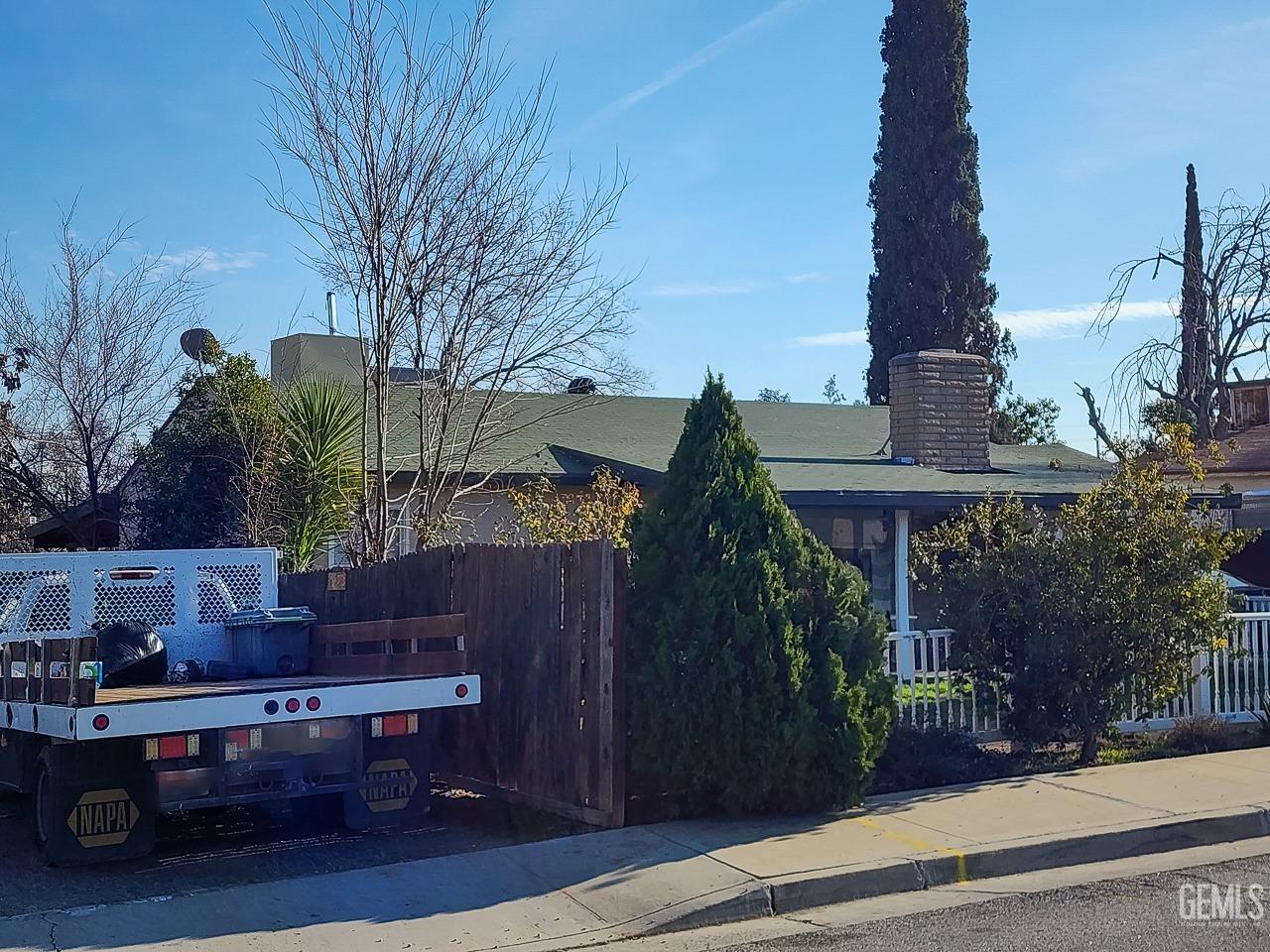 Undisclosed Address Bakersfield, CA 93305 - Photo 2 of 12 a backyard of a house with barbeque oven fire pit table and chairs