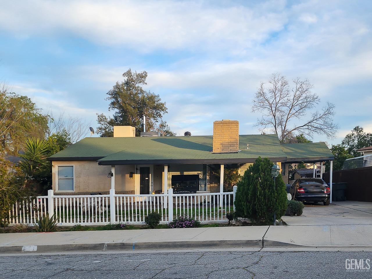 Undisclosed Address Bakersfield, CA 93305 - Photo 6 of 12 a front view of a house with a garden