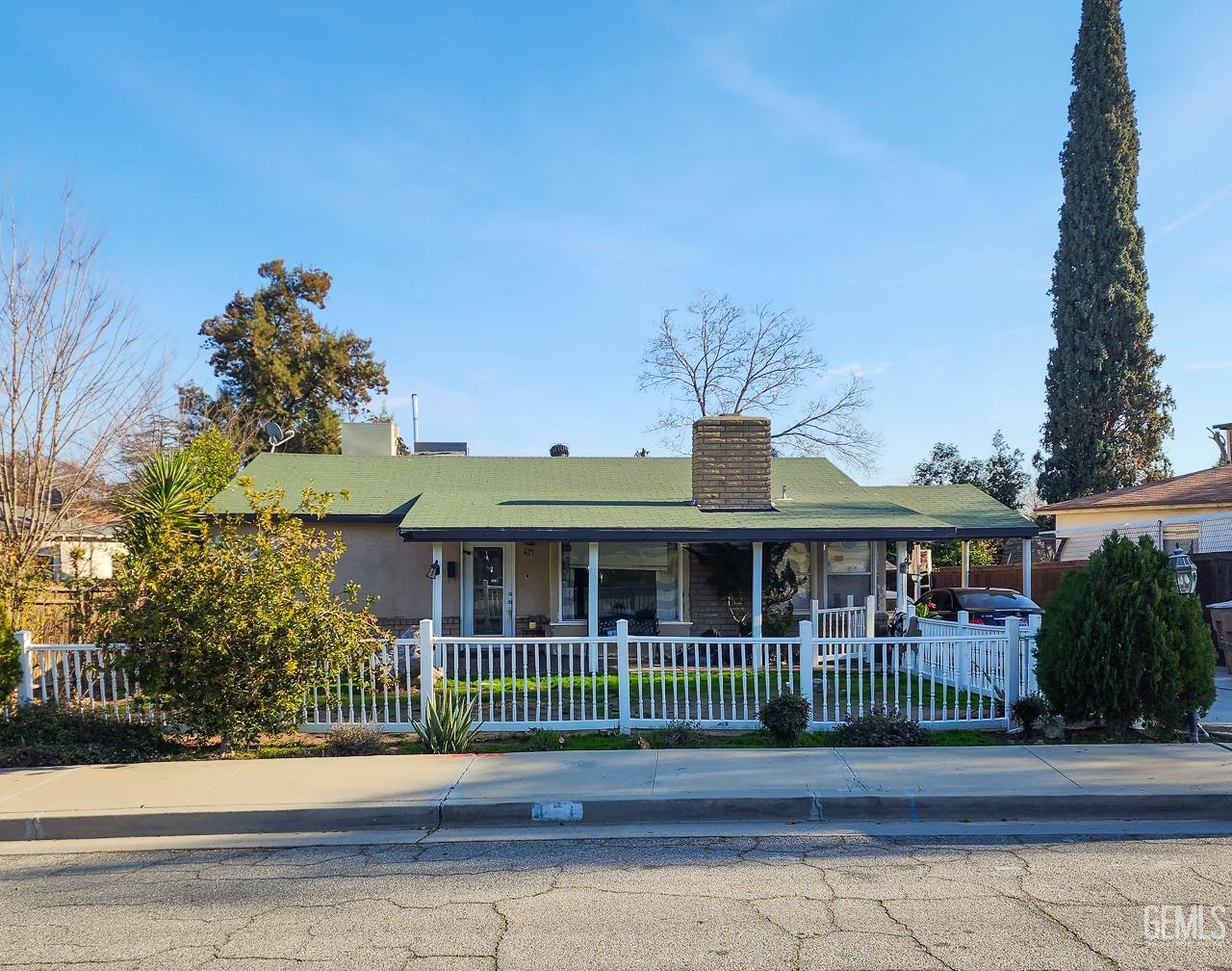 Undisclosed Address Bakersfield, CA 93305 - Photo 7 of 12 a view of a brick house with a large window and wooden fence