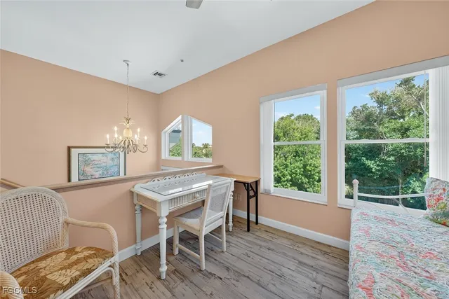 a view of a dining room with furniture and a window
