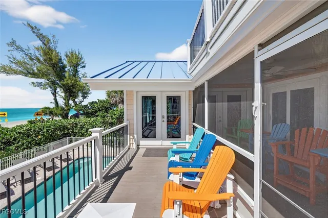 a view of a chair and tables in the balcony