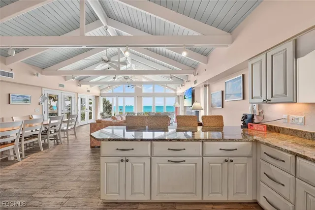 a kitchen with cabinets appliances and a wooden floor