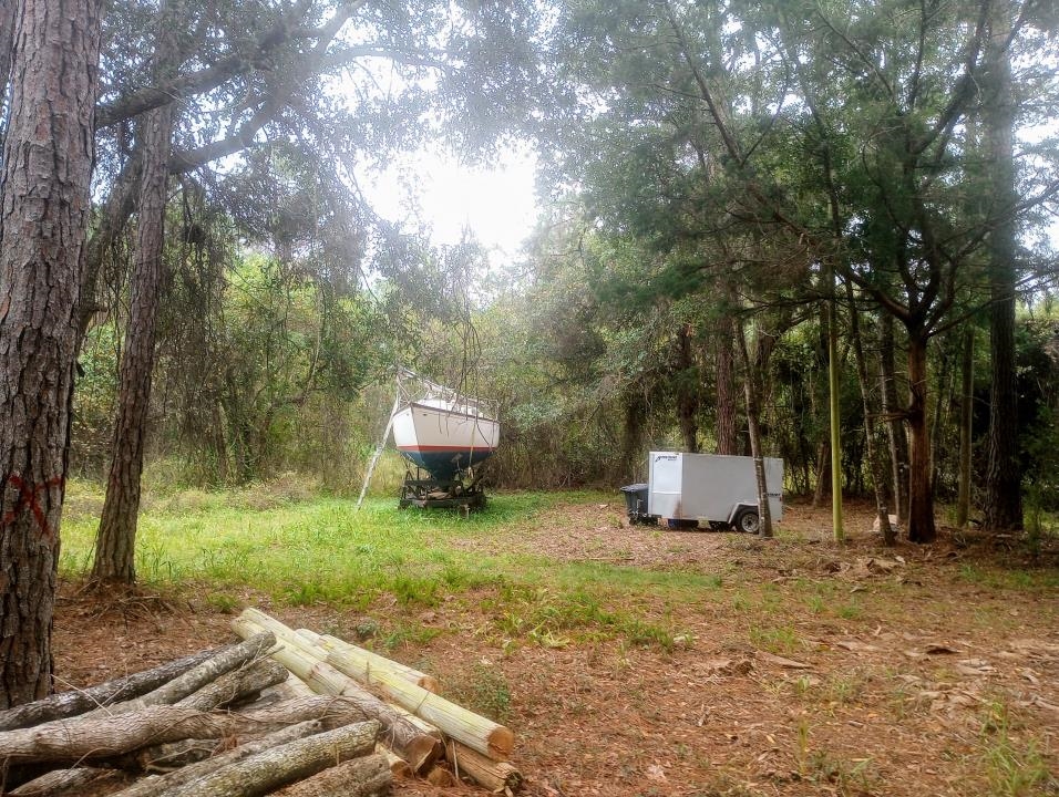 2890 Hilltop Road St. Augustine, FL 32086 - Photo 5 of 11 a view of a wooden house with a yard