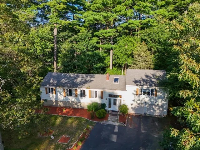 an aerial view of a house with a yard