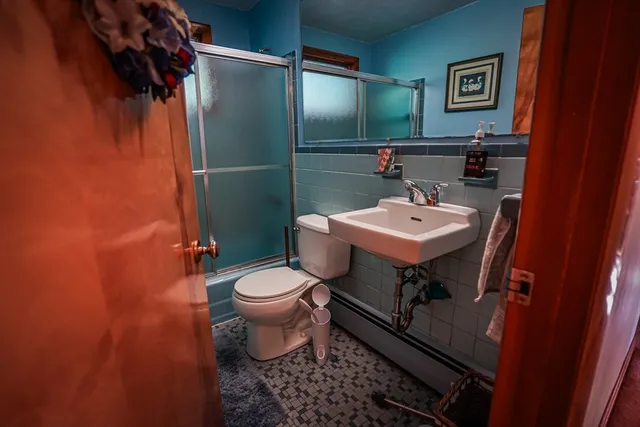 a bathroom with a sink toilet and a mirror