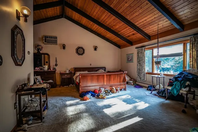 a bedroom with furniture and a large window