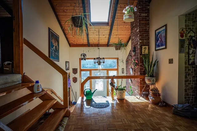 a view of an entryway with wooden floor