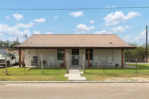 a view of a house couches yard and kitchen
