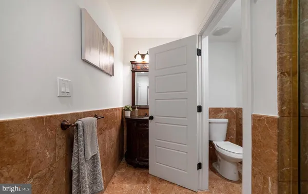 a bathroom with a toilet and a shower