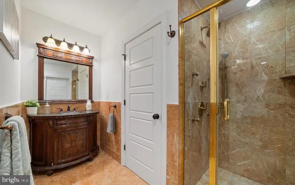 a bathroom with a double vanity sink mirror and shower