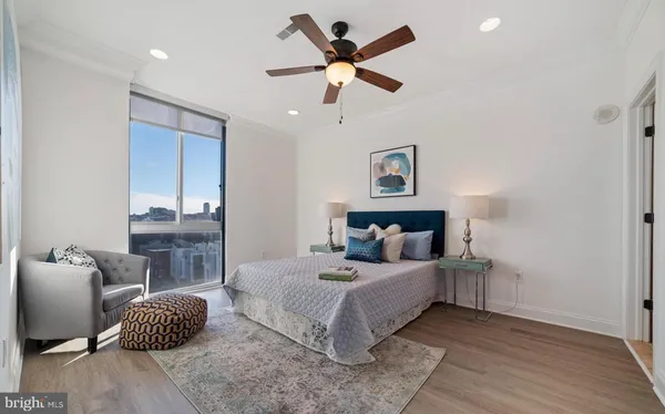 a bedroom with a bed and ceiling fan