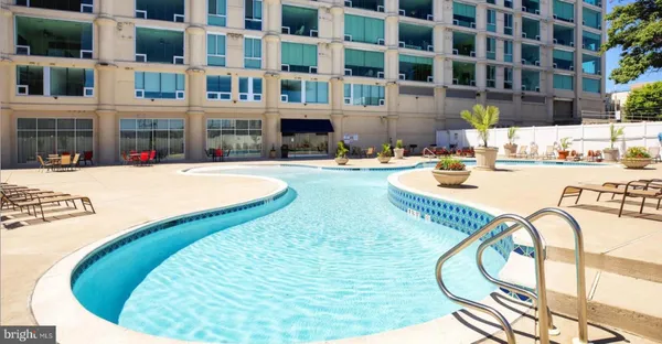 a swimming pool with outdoor seating and yard
