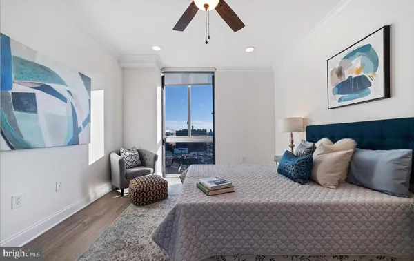 a bedroom with a bed couch and window