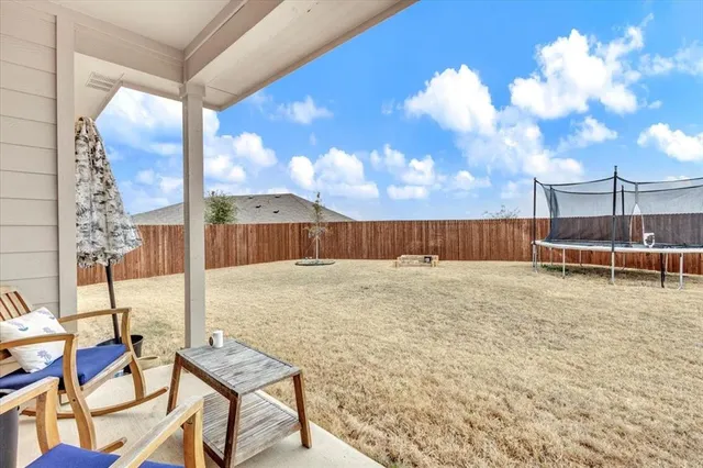 a view of a swimming pool with a yard