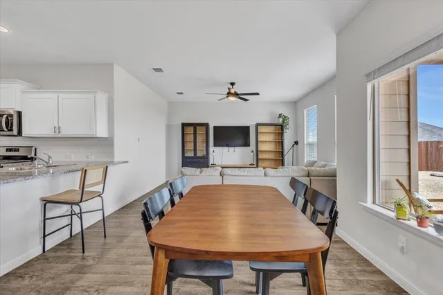 a kitchen with a dining table and chairs