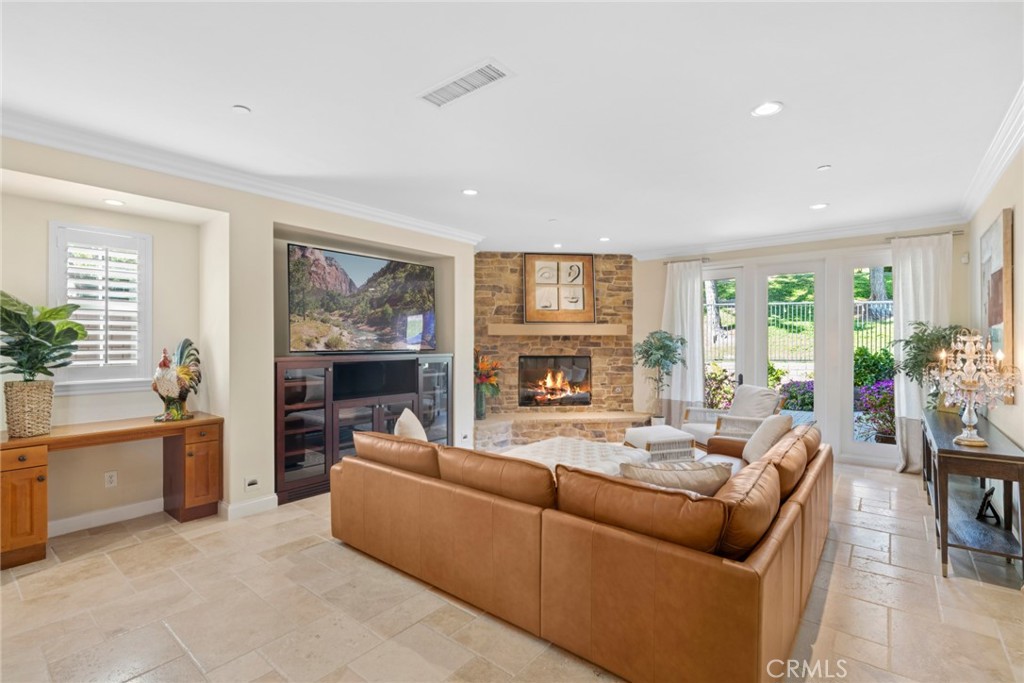 2 Ali Lane Ladera Ranch, CA 92694 - Photo 11 of 75 Family room with custom media niche, built in desk facing gorgeous fireplace and backyard