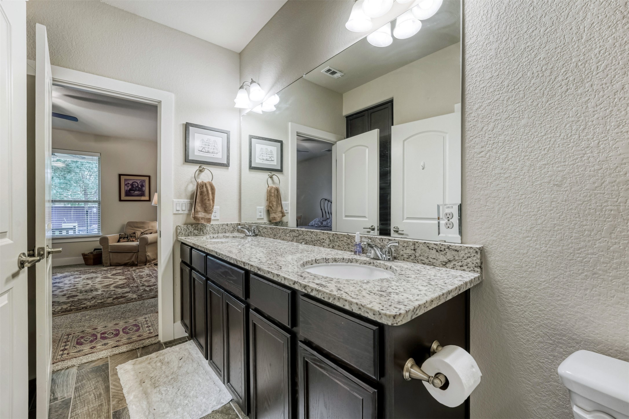 418 High Tech Drive Georgetown, TX 78626 - Photo 17 of 34 Dual vanity with granite countertop, integrated sinks, and dark wood-finish cabinetry