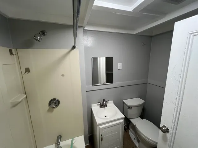 a white toilet sitting next to a bathroom sink