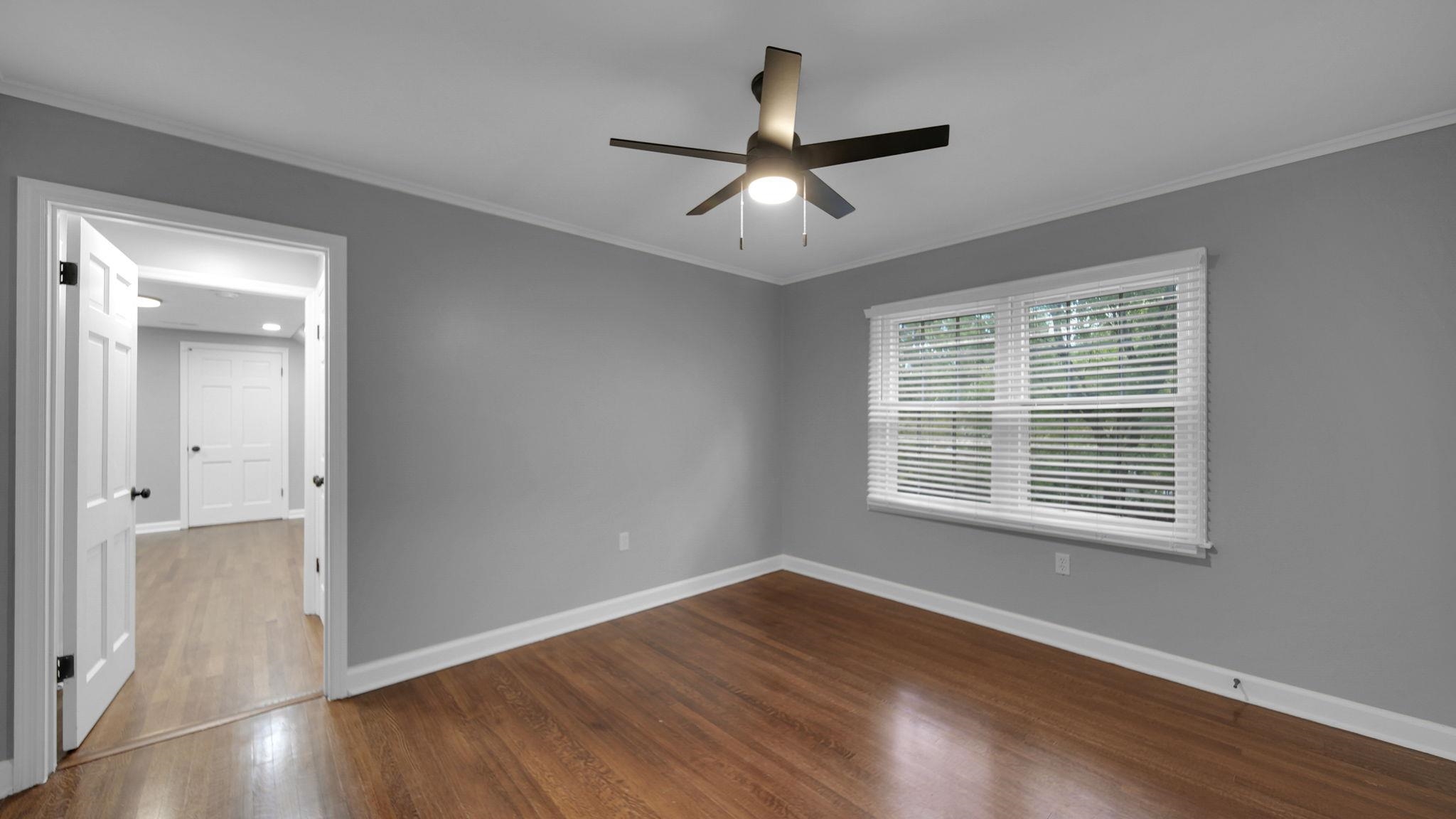 5256 Collingwood Road Memphis, TN 38117 - Photo 33 of 40 Empty room with crown molding, dark wood-type flooring, and a ceiling fan